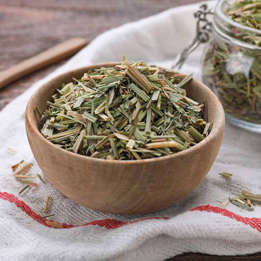 Freeze-dried lemongrass in a wood bowl on a tea towel